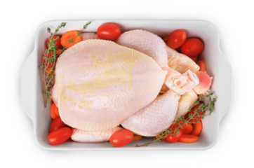 Raw whole chicken in baking dish with tomatoes, carrots and thyme isolated on white. Ready for roasting. High quality photo