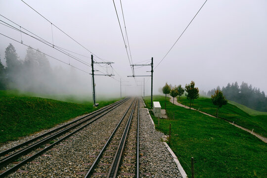 Railway tracks and power lines on foggy Mount Rigi, Switzerland