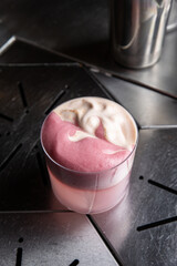 A delicious alcoholic cocktail at the bar. The bartender prepares cocktails