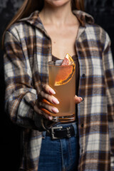 A delicious alcoholic cocktail at the bar. The bartender prepares cocktails