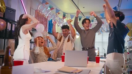 Excited Asian colleagues celebrating an "congratulation" achievement and Happy New Year 2026 in a office party,holding golden foil balloons Number 1.Concept of team celebration and holiday party