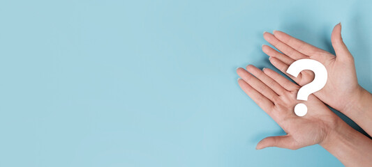 International ask a question day concept, Hand holding question mark icon on blue background with copy space, Answer, Q&A, Communication and Brainstorming