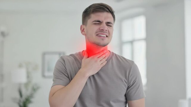 A man with a red face and eyes closed is sneezing in this . His expression is one of discomfort or embarrassment.