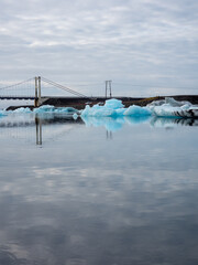 Bridge over Glacier Lagoon in Iceland with icebergs floating