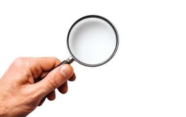 Searching for hidden insights with a magnifying glass held by a human hand looking for answers and solutions