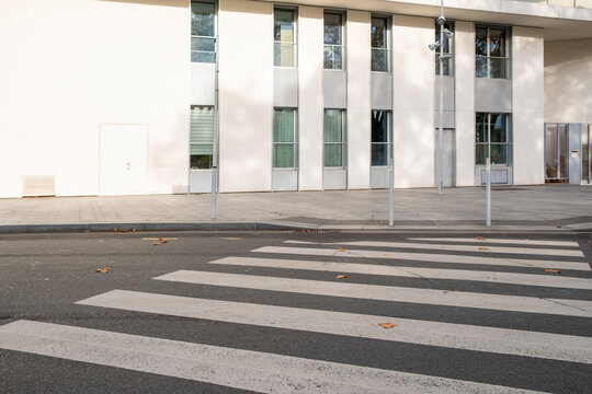 Modern urban structure rises in Paris as exterior lines connect pavement, road and street elements, blending city mobility with architecture in a clean empty setting