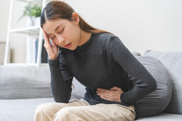 Flatulence ulcer, asian young woman, girl hands in belly, stomach pain from food poisoning,...