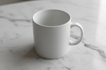 Obraz premium White mug mockup with handle rests on white surface with grey marble pattern. Natural light shines from above, illuminating mug's simple design