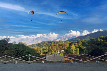Paragliding over the clouds sunset view at Bir Billing Himachal Pradesh India. Clouds in the sky, Dhauladhar snow peaks.