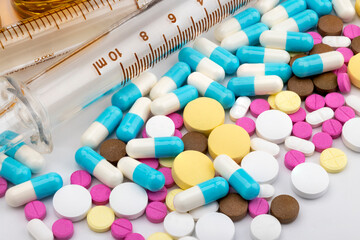 Heap of different pills on white isolated background , Pharmaceutical background