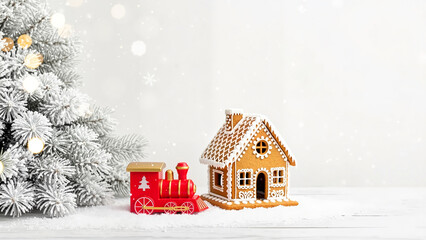 Child-friendly gingerbread house with toy train and Christmas tree, perfect for holiday decorations and children's products
