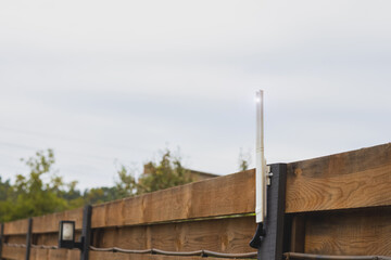 Wi-Fi router outdoor on fence near the house.