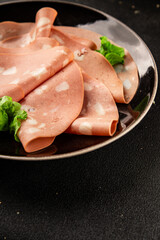 Mortadella sausage slices meat food tasty snack fresh delicious gourmet food background on the table rustic food top view copy space