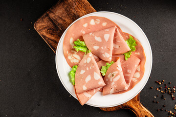 Mortadella sausage slices meat food tasty snack fresh delicious gourmet food background on the...