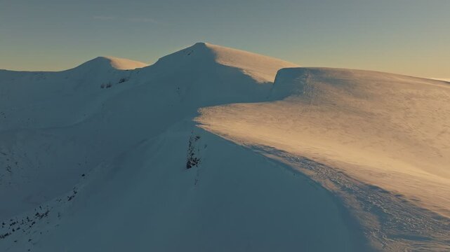 Peaceful morning over mountain ranges, Silent sunrise illuminating snowcapped summits, Serene morning glow gently illuminating snowclad mountain heights with warm light