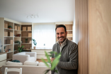 Fototapeta premium Man smiling portrait in modern living room at home