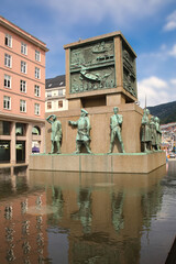 Sailor's Monument - Spuare shaped statue with nautical figures surrounded by water on one of the main shopping streets in the downtown, Historical landmark in Bergen, Norway