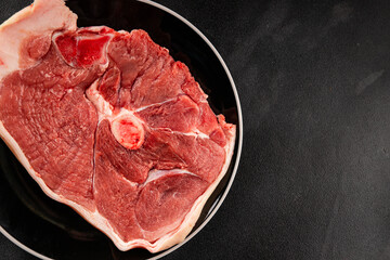 Bone-in ham steak, raw pork ham on the bone tasty snack fresh gourmet food background on the table  rustic food top view copy space