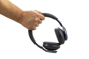 A hand holding black wireless over-ear headphones with cushioned ear pads against a white background in a close-up view.