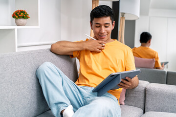 Young man using digital tablet working remotely