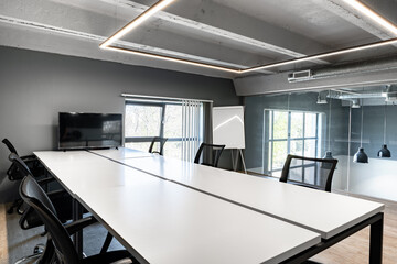 Modern conference room with large table and sleek design suitable for meetings and collaboration