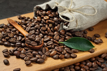 coffee beans in linen bag. wooden background