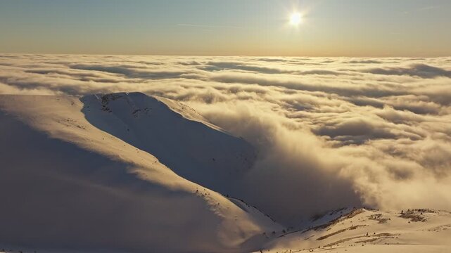 Morning glow on icy peaks, Pre dawn illumination highlighting snowtopped ridges and mist, Early morning luminous scene showing icy mountain heights shrouded in fog and shadow