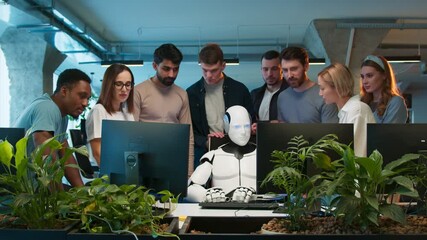 Team of engineers gathered around workstation. Mixed group discussing malfunction while robot sitting idle at center. Developers analyzing issue and sharing concerns. In collaborative tech environment - Powered by Adobe