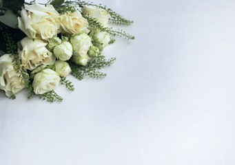 A bouquet of white roses on a white background with space for text. Background for congratulations, invitations.