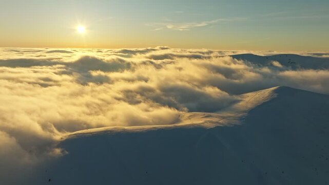 Bright dawn spectacle, Sunrise illuminating sky and terrain, Vivid morning glow over clouds and snow, Majestic dawn casting golden hues over expansive landscape