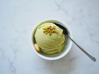 Vanilla ice cream in a bowl with mint garnish on a plate
