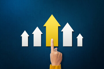 A man select carry yellow arrow pointing upwards. represents development path direction success statistics growth aim achievement