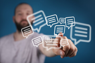 Close-up of a man's finger interacting with floating chat bubbles. Represents communication, messaging, and social media. Perfect for tech, busi
