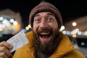 Excited person holding a winning lottery ticket.
