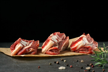 raw beef ribs with spices and herbs on a stone background.top view.