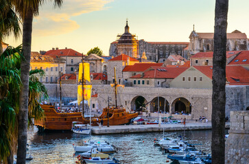 Sunset panoramic view on walls and port of famous old city Dubrovnik, Croatia