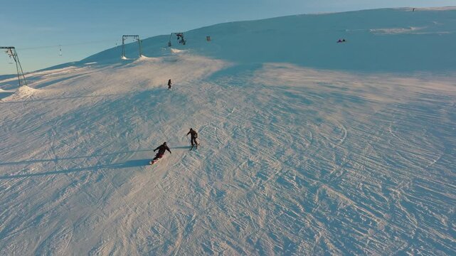 Explorers on snow, Adventurers journey across vast icy plains illuminated by shadows, Two travelers navigate sprawling snowfield shaped by gusty winds and light footprints
