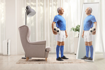 Full length shot of a fit elderly football player holding a ball