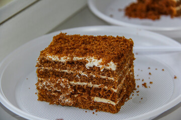 pieces of chocolate cake with white cream lying on plates, birthday, disposable tableware, forks, dessert,