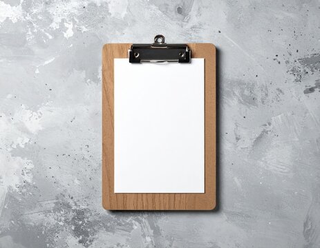 Blank Clipboard with White Paper and Metal Clip on Textured Gray Concrete Background