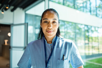 Adult nurse smiling confidently in modern hospital