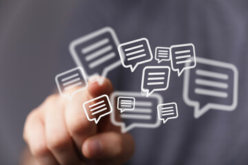 Hand interacting with virtual speech bubbles, representing communication, messages, and social media. Ideal for technology, connectivity concept