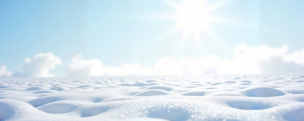 Sun shining over snowy landscape with gentle clouds in winter  