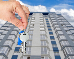 Hand holds the keys to a new apartment