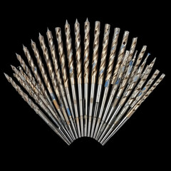 Collection of titanium coated drill bits fanned out against a stark for tools