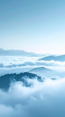 Fototapeta premium Serene Mountain Peaks Emerge from a Sea of Clouds Under a Hazy Blue Sky
