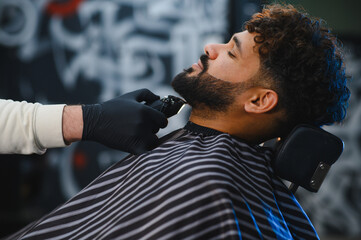 Client receiving modern beard trim at barbershop