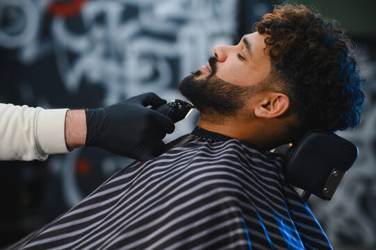 Client receiving modern beard trim at barbershop