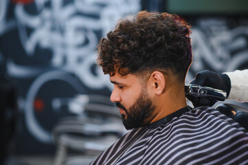 Man getting modern haircut in barbershop