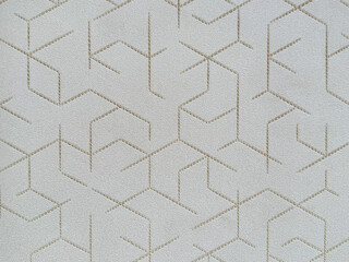Graphic of grey background with geometrical hexagon shape pattern in gold color. For wallpaper, covering, fabric, or wall panel. Seamless background texture.